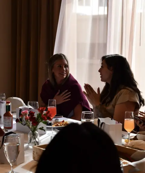 Two SugarCon attendees having fun conversation at Bad Bitch Breakfast